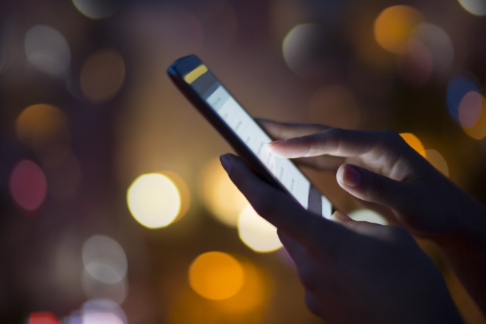 Mobile phone screen illuminated at night