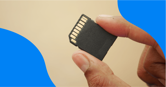 Holding a camera memory card between two fingers