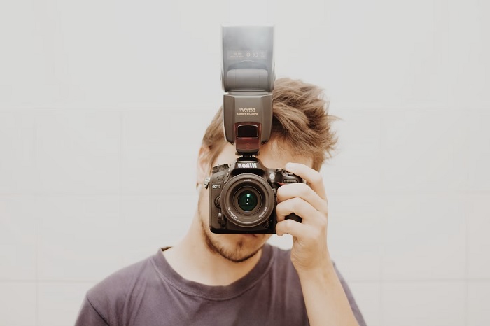 Photographer using a camera with an external flash