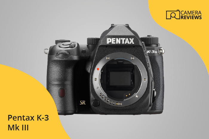 Pentax K-3 Mark III photographed on a colored background