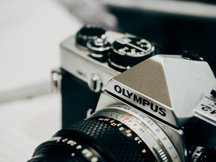  a closeup of an olympus film camera
