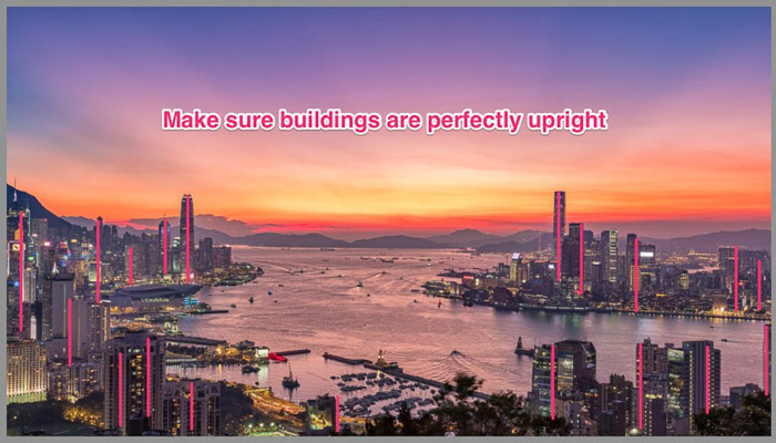 A colorful cityscape at sunset with the words "make sure buildings are perfectly upright"